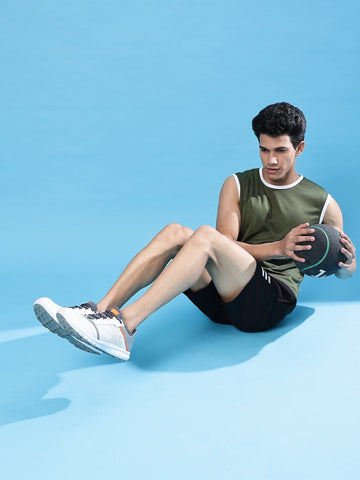 man doing squats holding ball