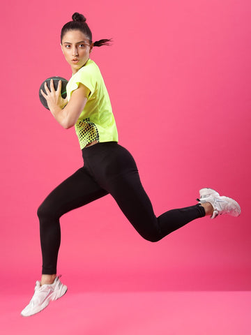 women doing squats holding ball